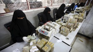 Money exchangers count stacks of Yemeni rials in of the Central Bank of Yemen in Sanaa, Yemen