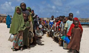 children-from-southern-somalia-hold-their-pots-as-they-line-up-to-receive-food-aid-during-the
