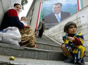 A mother and her children beg in a pedestrian underpass as a picture of Tajik President Emomali Rakhmonov is featured on a building in Dushanbe, 23 October 2006. The post-Soviet nation now owes a total of 830 million US dollars to foreign creditors, including 510 million US dollars to international finance organizations such as the World Bank (307 million US dollars), the Asian Development Bank (100 million US dollars) and the Islamic Development Bank (41 million US dollars). AFP PHOTO / VYACHESLAV OSELEDKO